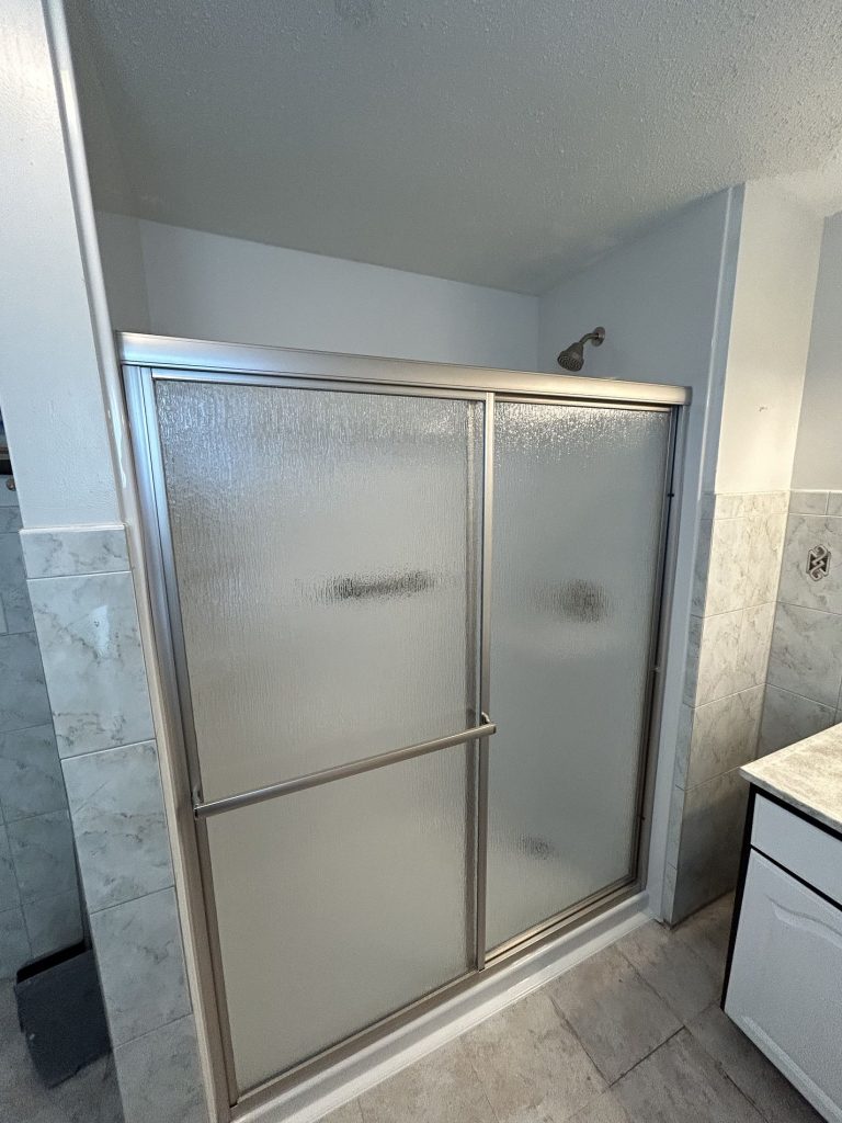 sliding shower door with rain glass and brushed nickel finish