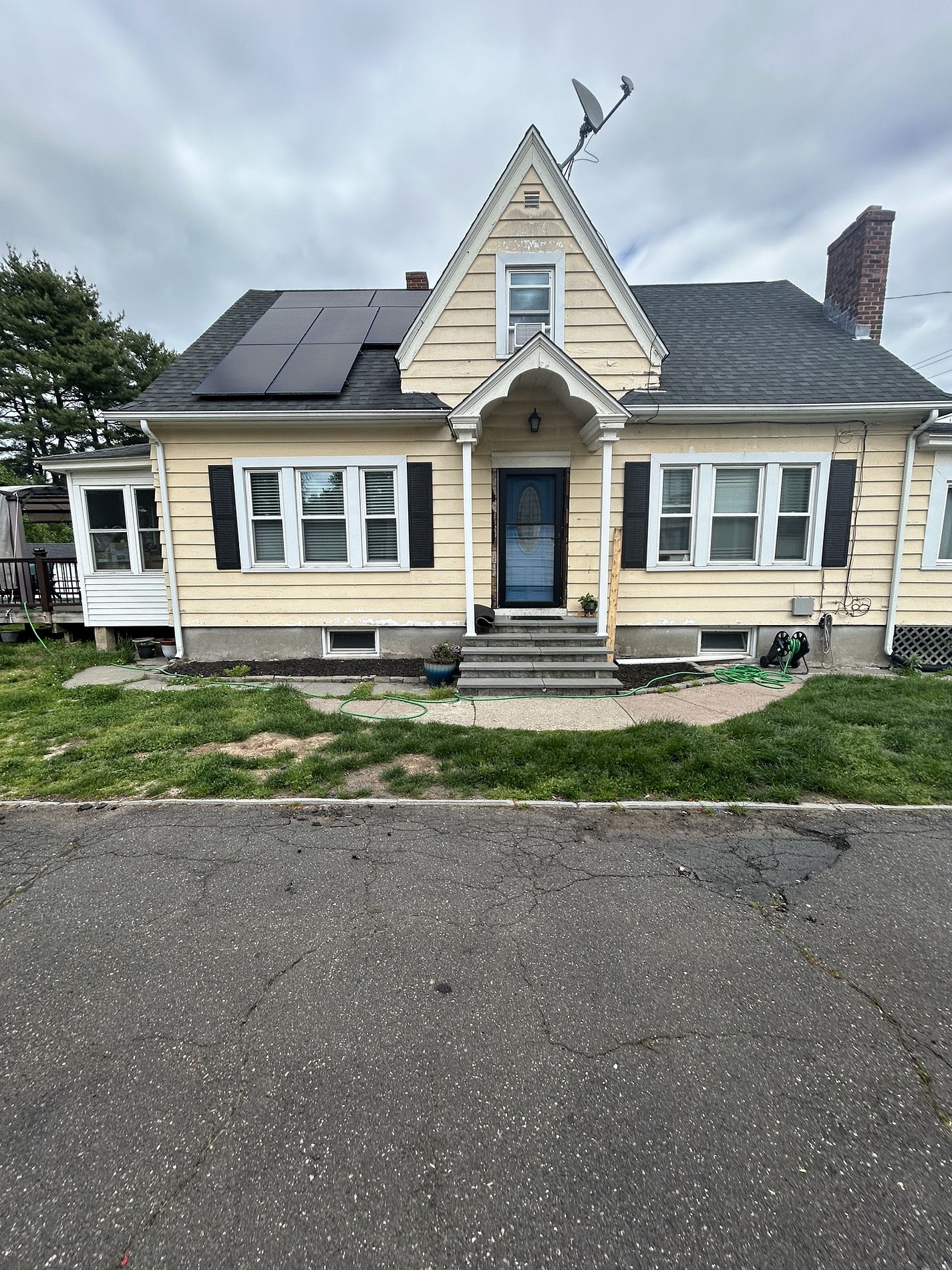 McKee Street East Hartford CT home with faded yellow siding and peeling portico trim before renovation