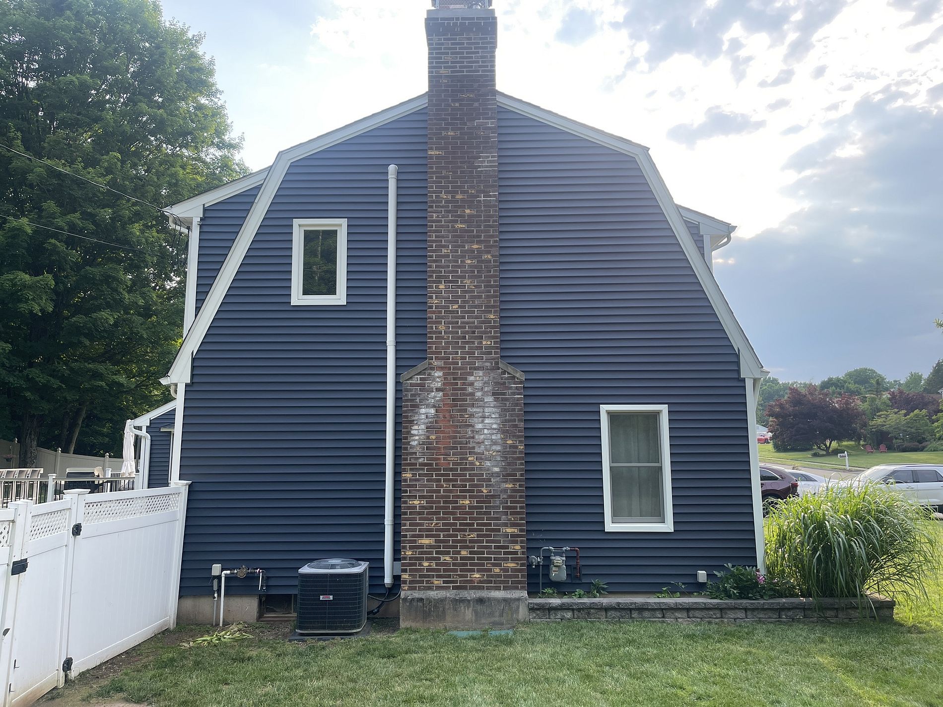 After photo of Anton Lane Berlin CT gambrel home with new deep navy blue Alside vinyl siding installed by Nu-Face Home Improvements