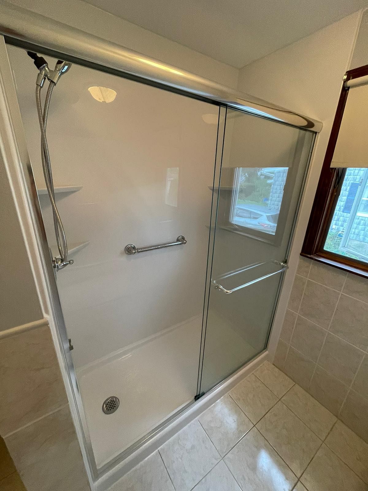 Completed shower conversion on Becker Avenue Berlin CT showing clean white Luxury Bath acrylic surround brushed nickel hardware and semi-frameless sliding door