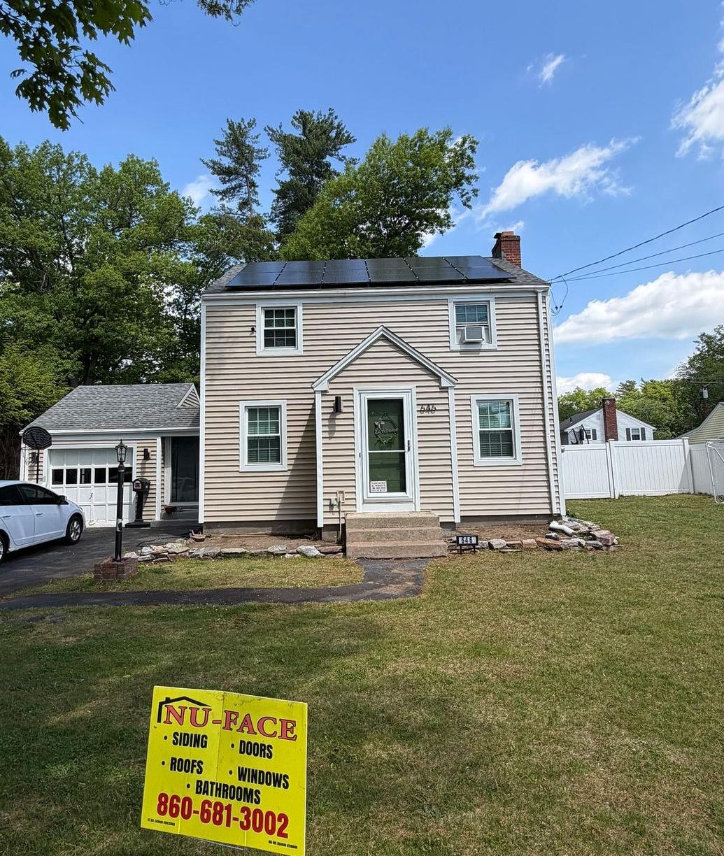After photo of new vinyl siding installation on front of colonial home