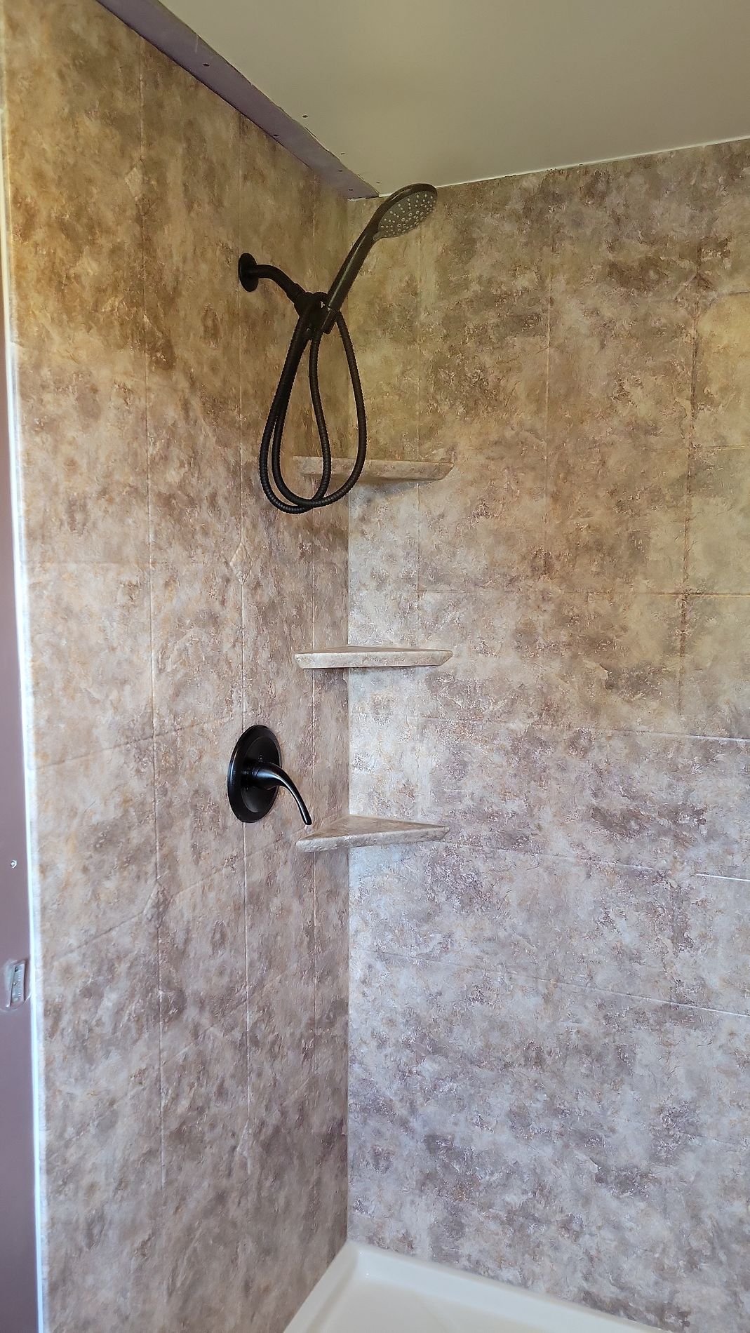 Completed bathroom remodel on Hills Street East Hartford CT showing new Luxury Bath acrylic wall panels and updated shower hardware