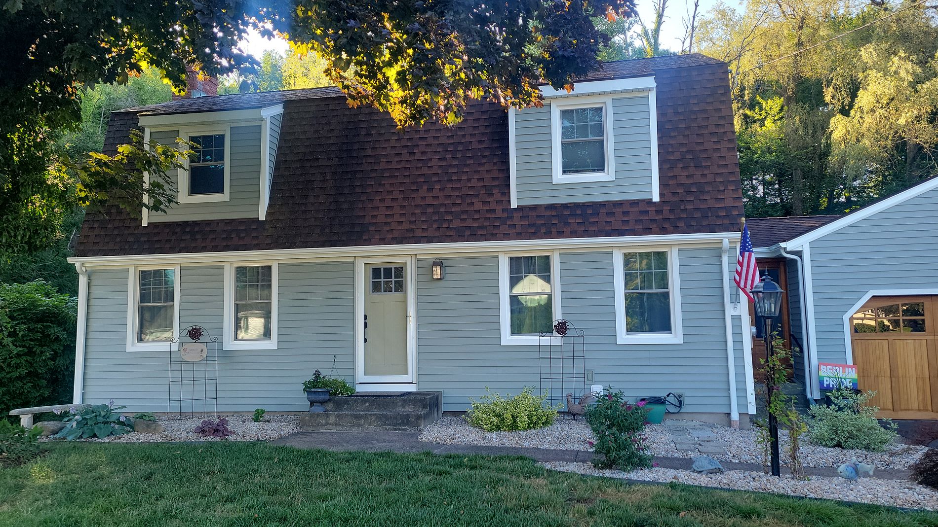 Completed Alside siding installation on a Cape Cod style home in Berlin, CT. New gray-blue vinyl siding with white trim by Nu-Face Home Improvements