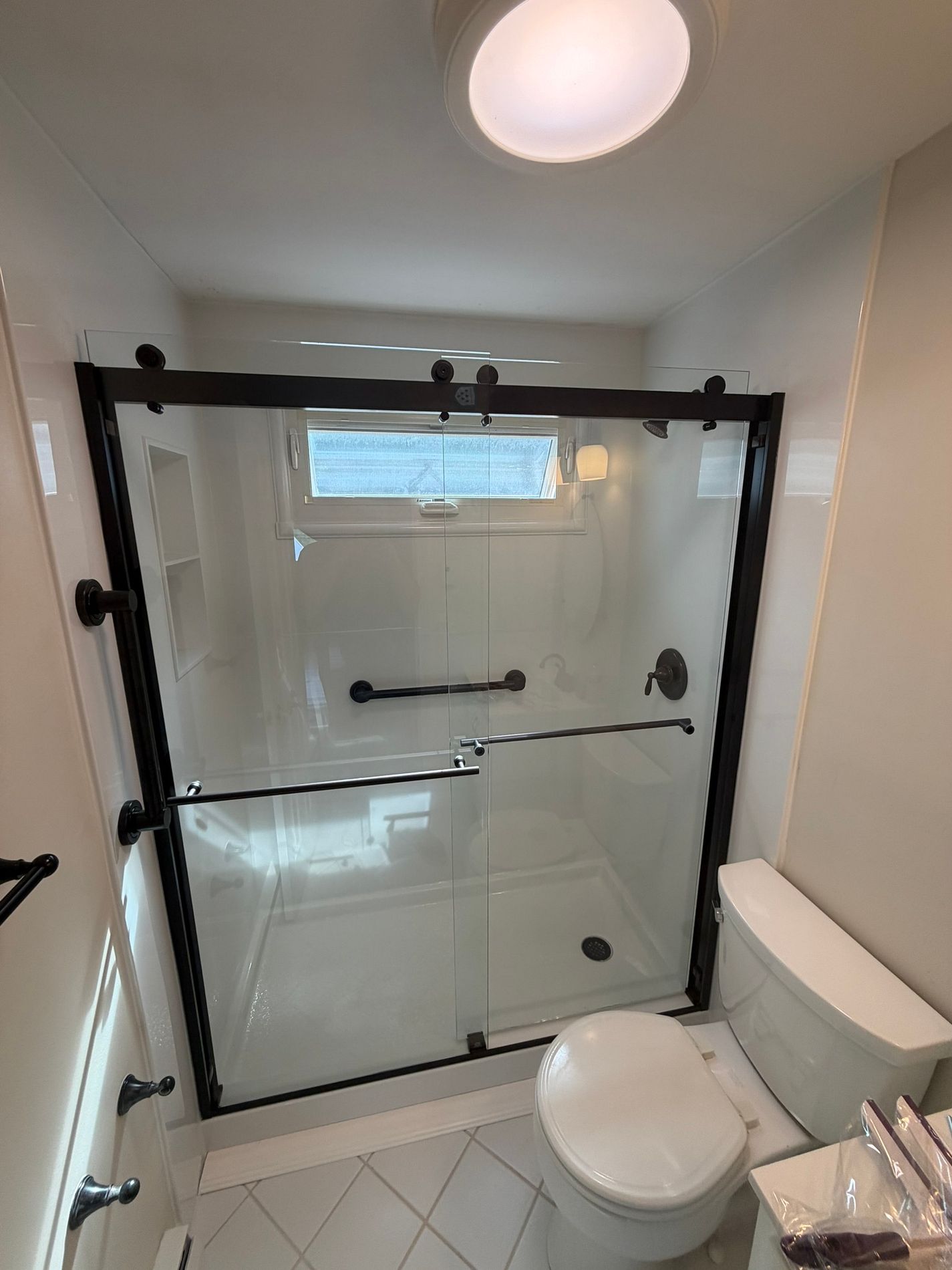 white acrylic walk in shower remodel with black frame