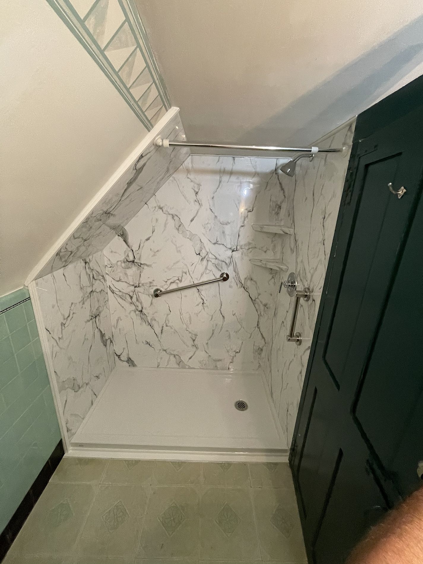 Completed walk-in shower on Reservoir Road Berlin CT fitted under sloped ceiling with Luxury Bath white marble acrylic panels grab bar corner shelving and curved glass door