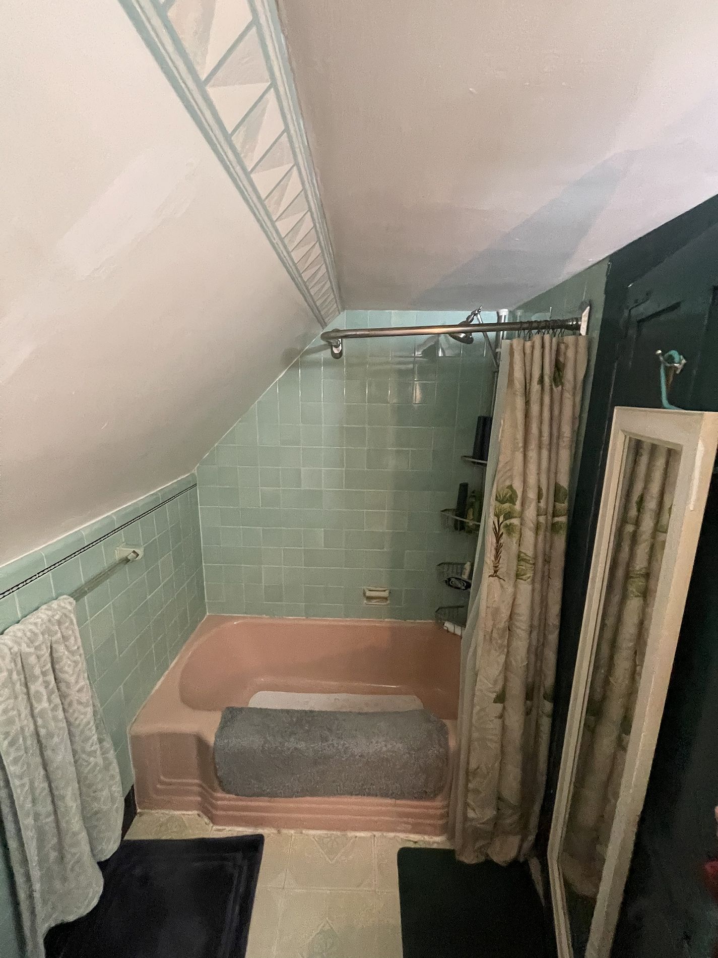 Original pink tub with green tile surround under sloped ceiling on Reservoir Road Berlin CT