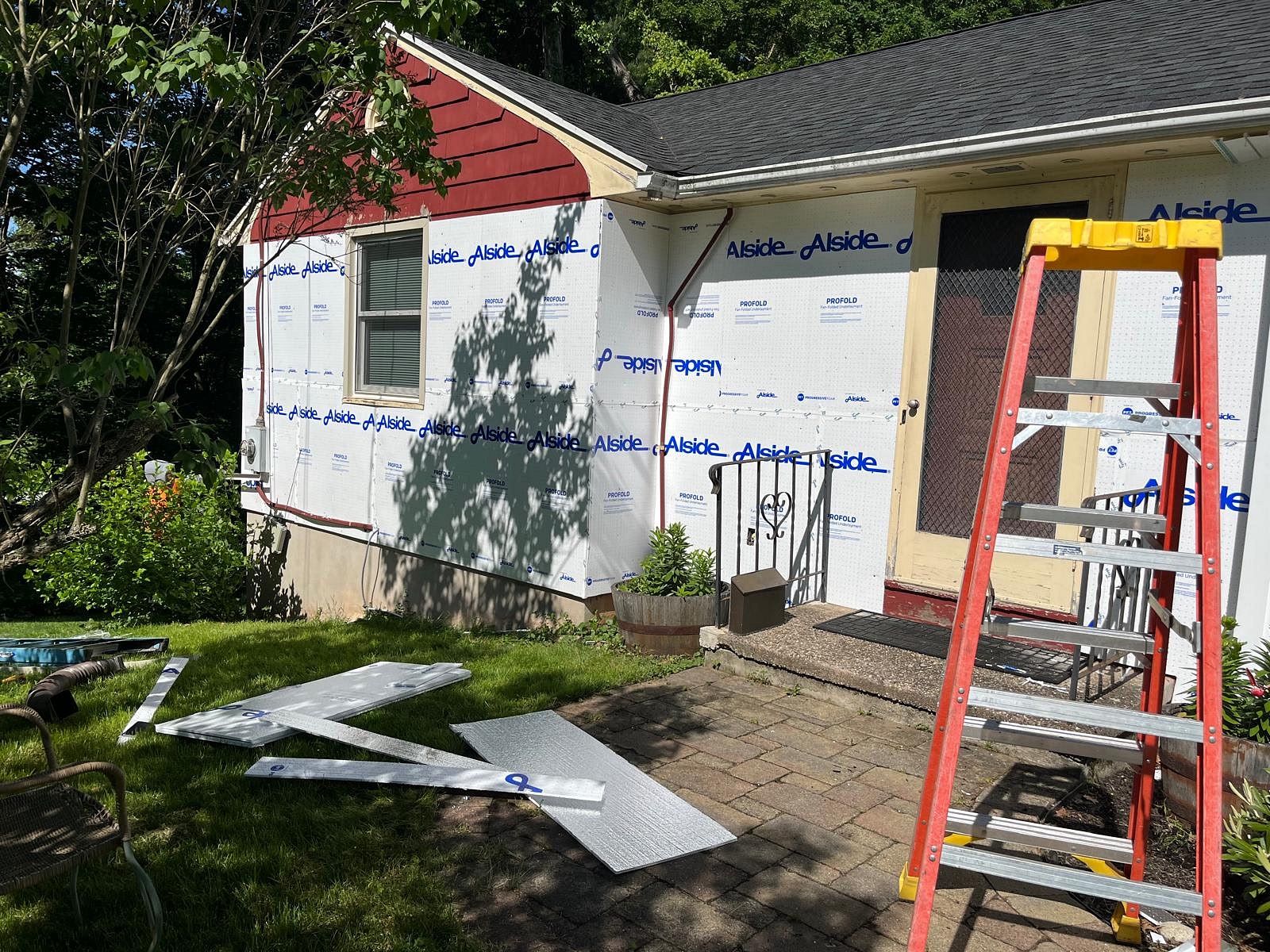 Nu-Face Home Improvements crew installing Alside Profold underlayment on Round Hill Road Berlin CT during full siding replacement project