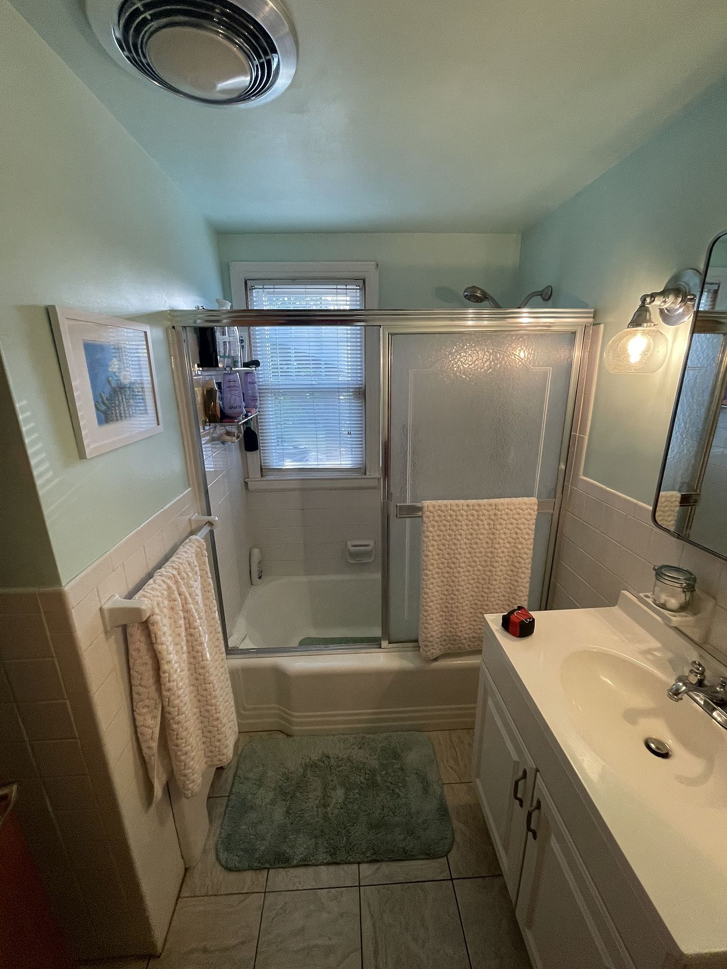 Original bathroom on Savage Hill Road Berlin CT showing tub with chrome framed sliding door and tile surround before Nu-Face gut renovation