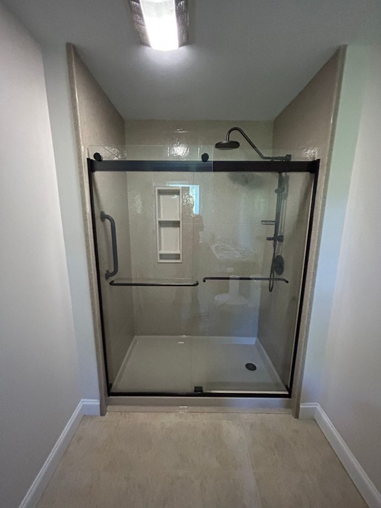 One piece shower base with glass enclosure