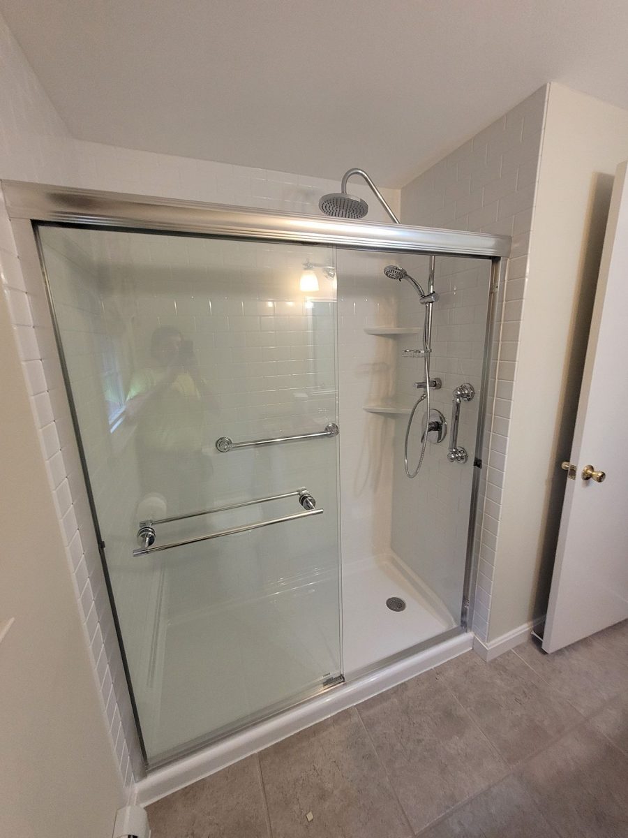 Completed walk-in shower on Warner Road Berlin CT with Luxury Bath white subway tile acrylic panels brushed nickel rain head and frameless glass sliding door installed by Nu-Face