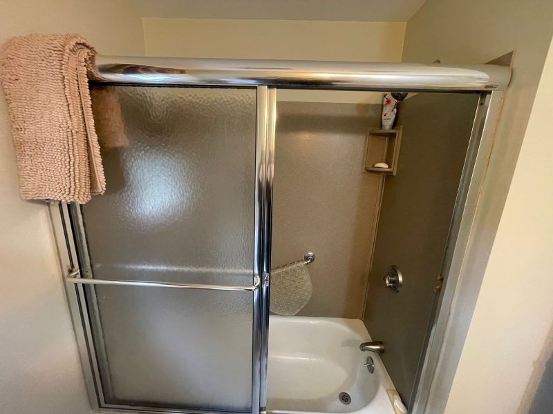 Original tan fiberglass tub surround with bronze framed door on Warner Road Berlin CT before Nu-Face conversion