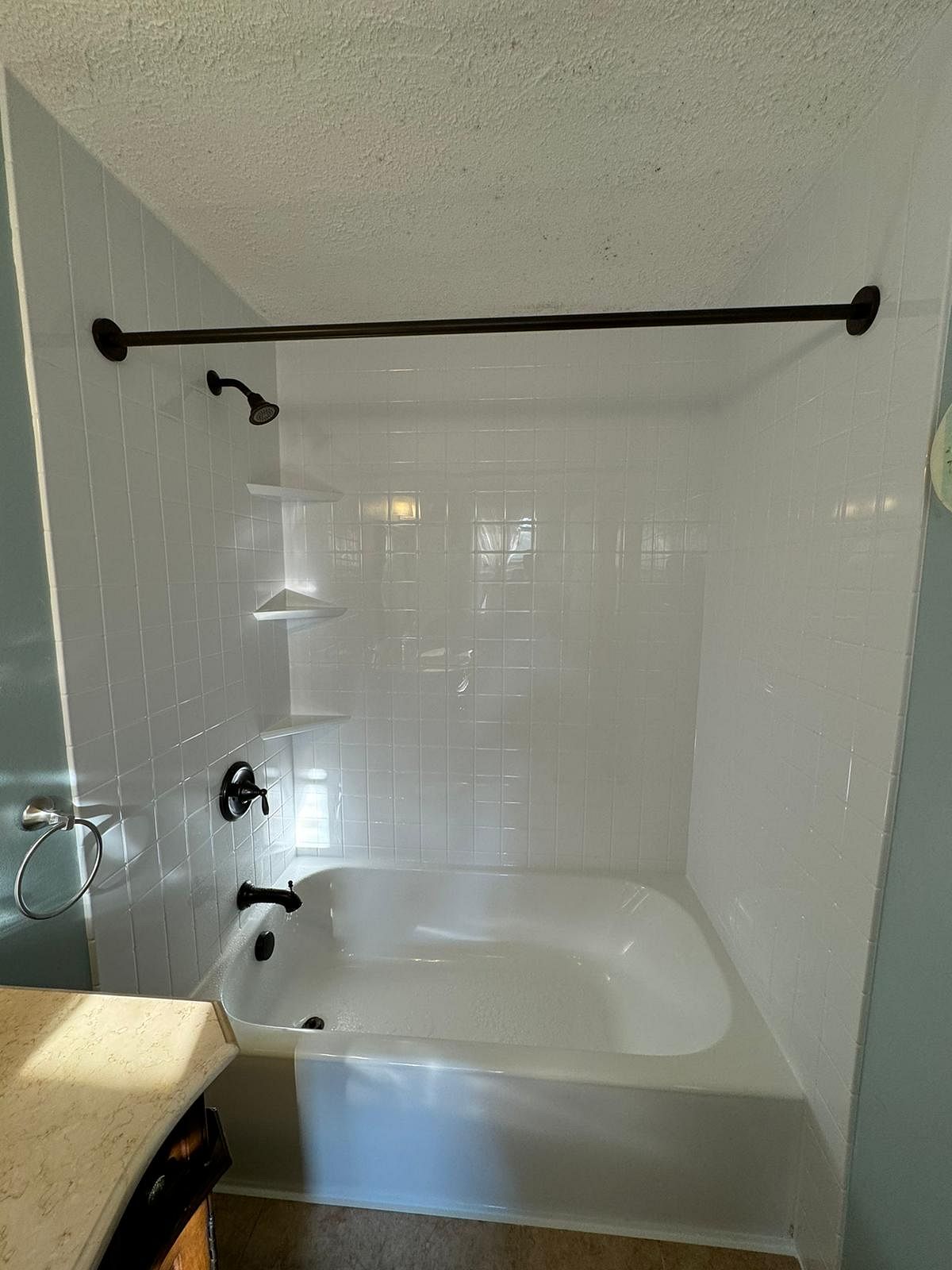 New subway tile-style shower with bronze fixtures on Murielle Drive in South Windsor, CT