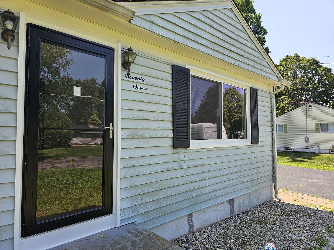 New window and storm door installed on a cape-style home on High Tower Road in South Windsor, CT