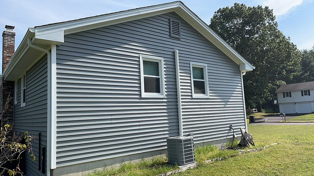 Completed window replacement viewed from the yard on Murielle Drive in South Windsor, CT